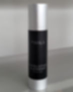 Skin Treatment | A studio picture of a Dr Hala exfoliating cleanser. The packaging is black with a silver lid and font.