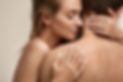 Skin Tightening | A white topless blonde woman with white painted nails hugging a topless man from the back. 