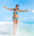 Exilis | A fit woman at the beach